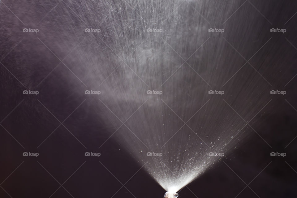 Jet of fountain splashes water drops