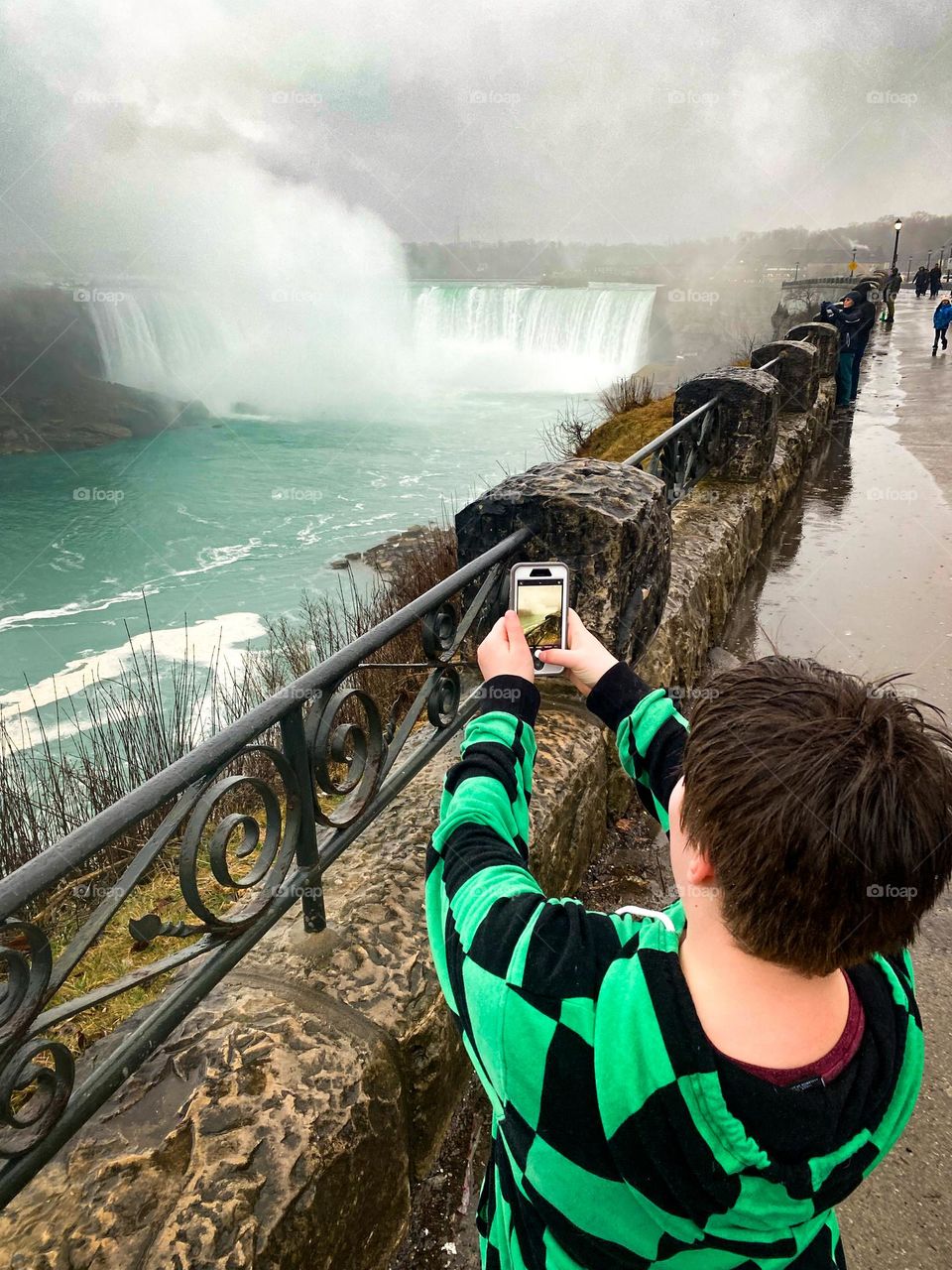 Tourist taking a video at Niagara Falls.
