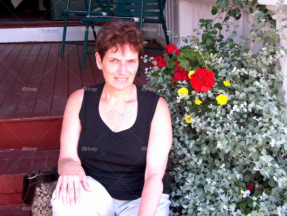 Woman sitting outdoors on steps at nature center 