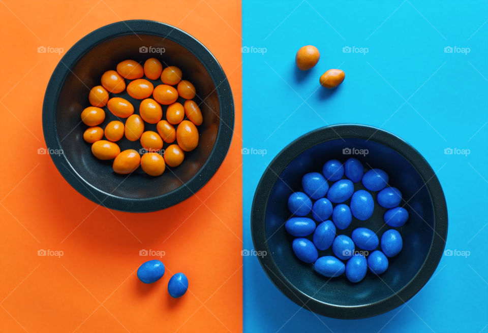 Colorful blue and orange candys on the table