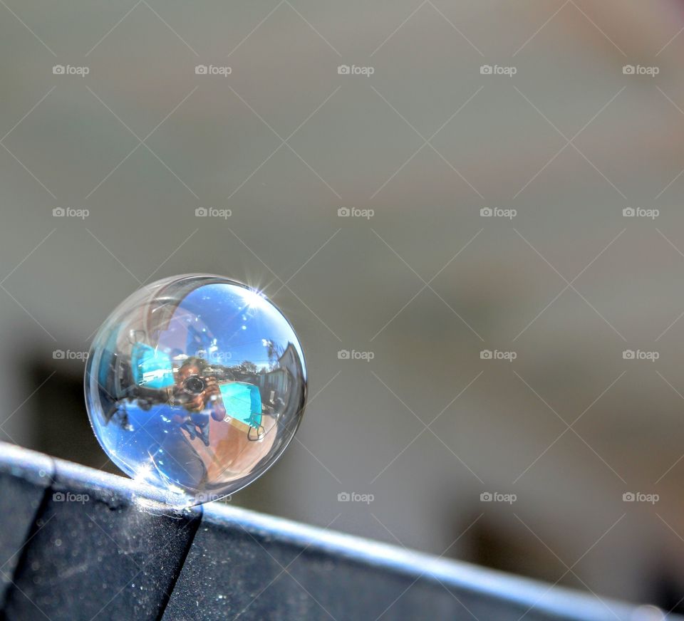 bubble reflection of a photographer and a swimming pool