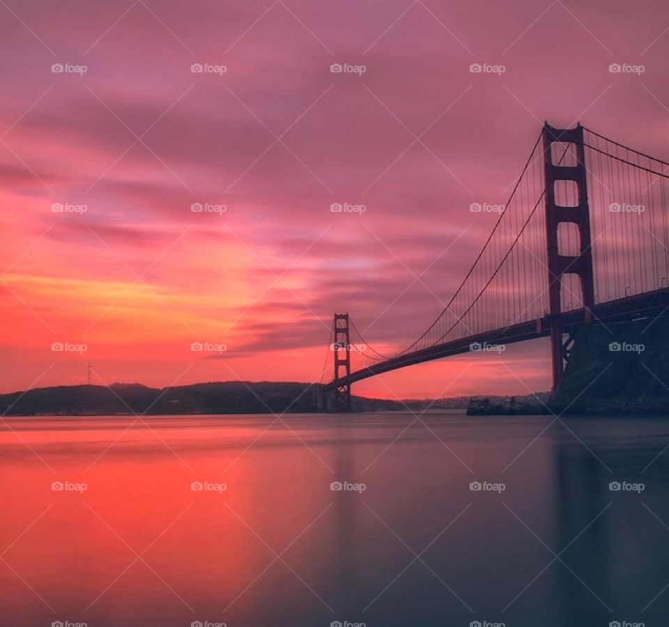 Golden Gate Bridge in a dark, but colorful sunset.