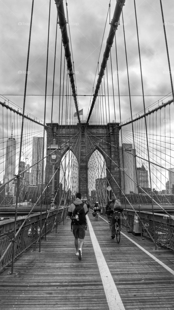 A view of commuters walking over the Brooklyn Bridge in New York.