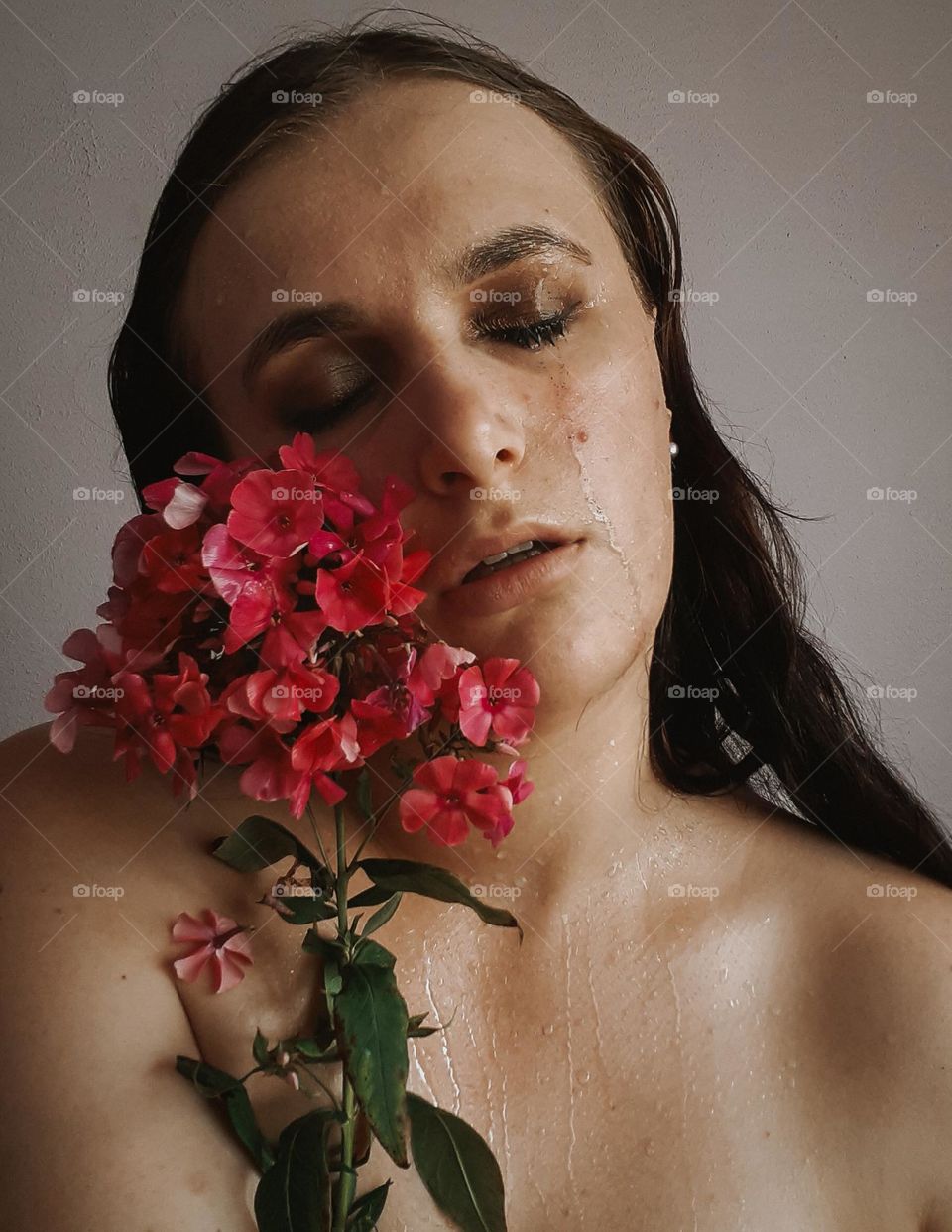 Portrait of a sad girl with flowers