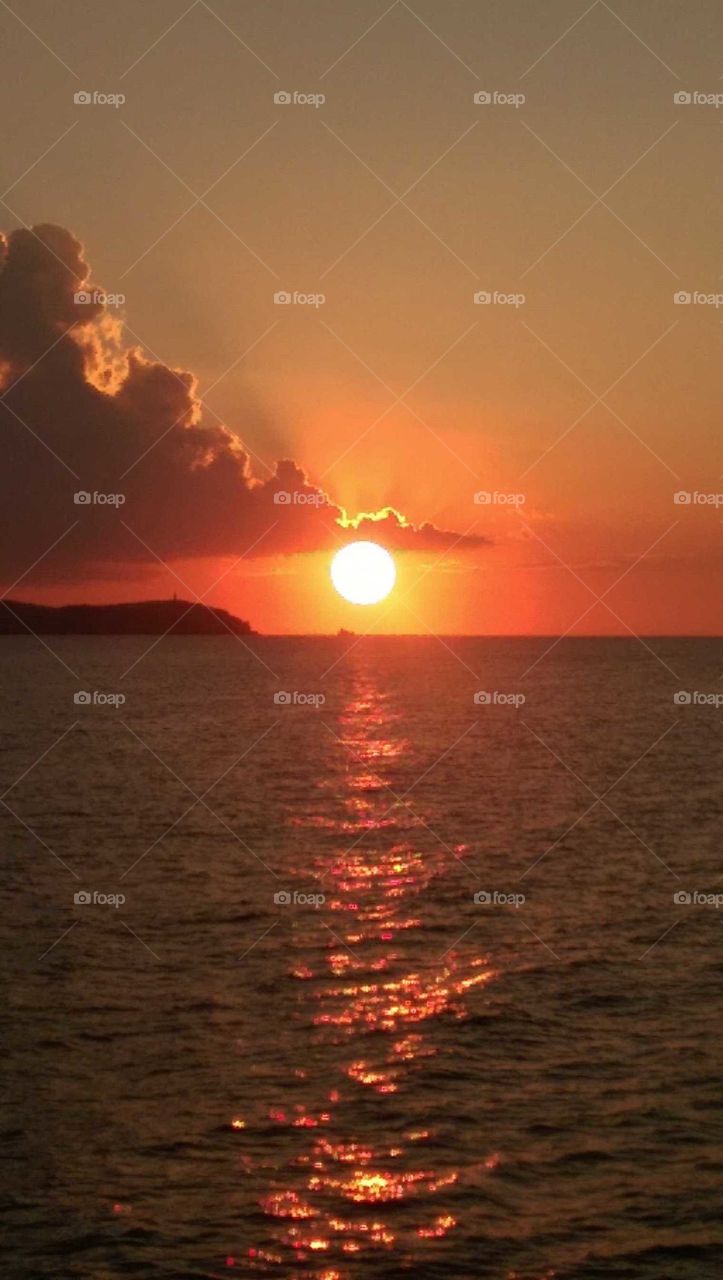 brilliant red sunset over the Mediterranean sea, displaying a beautiful halo glow