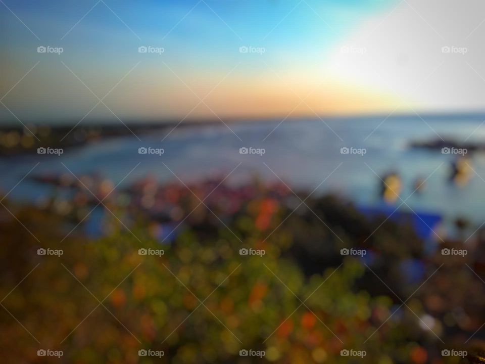 Defocused background abstract of beautiful beach sunset view from the top of the hill