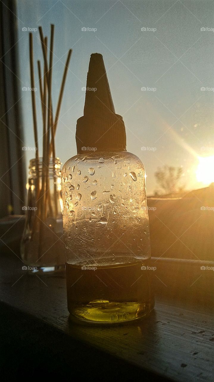 vape liquid with a sunset behind it