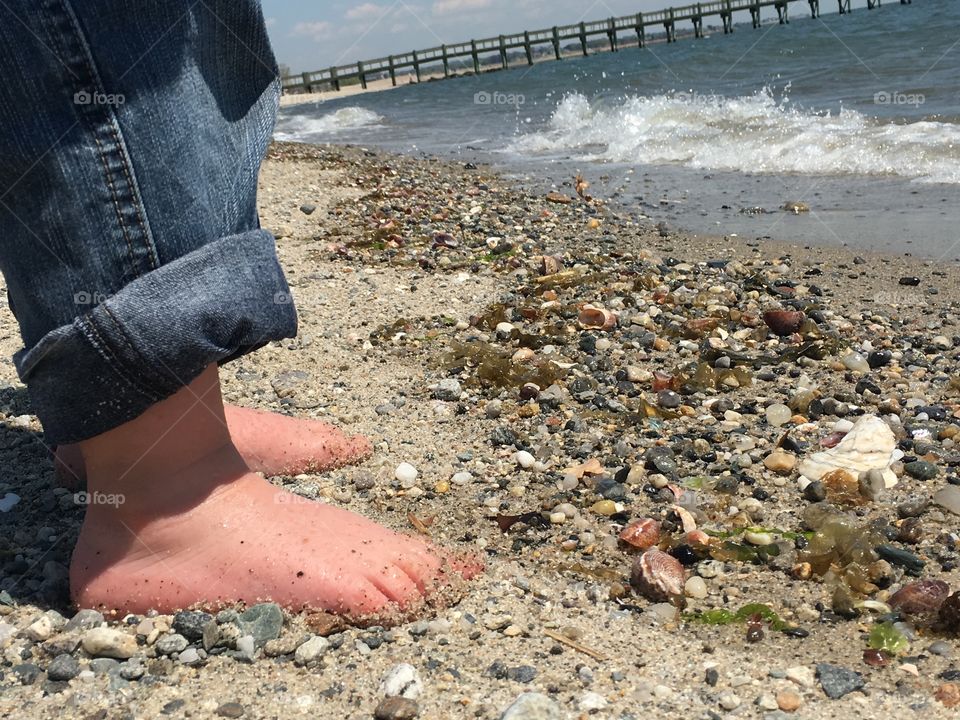 Toes in the sand on the Long Island sound .