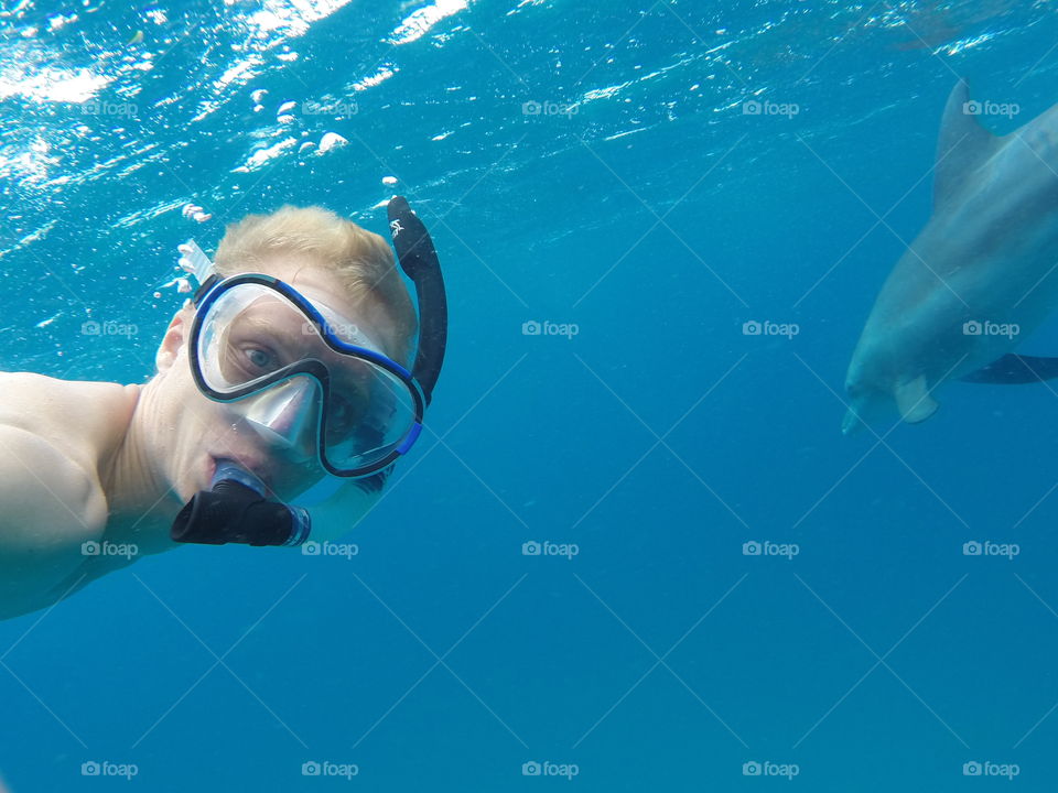 Scuba diver swimming underwater with shark