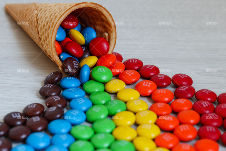 Waffle cornucopia with rainbow explosion of M&Ms chocolates