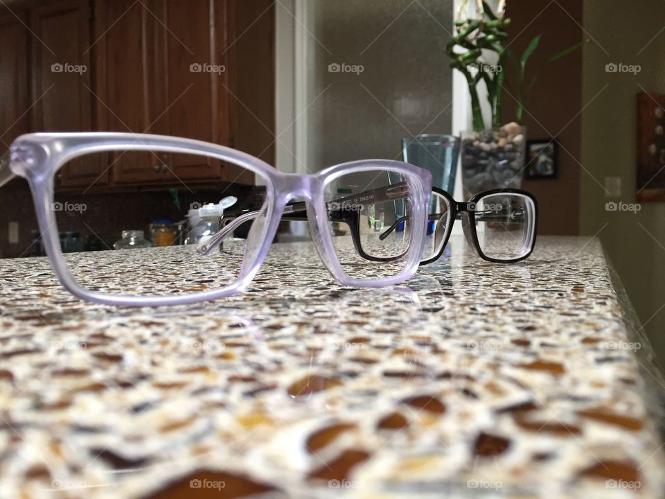 Classic black glasses frames, modern opaque glasses frames, on the countertop.