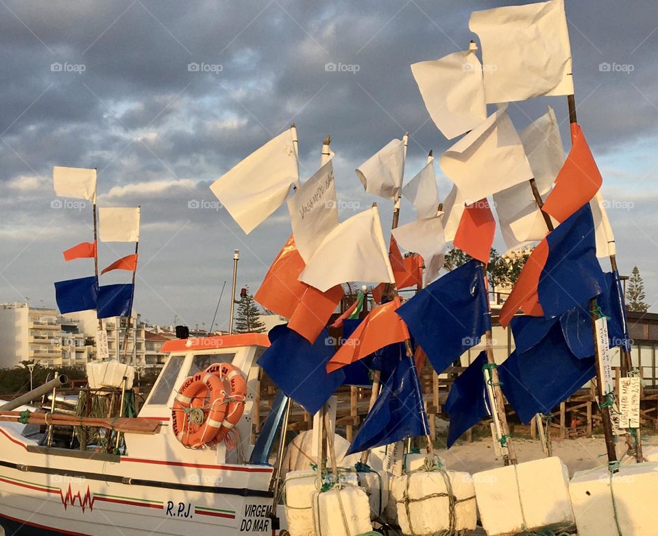 Fisherman colorful flags on beach