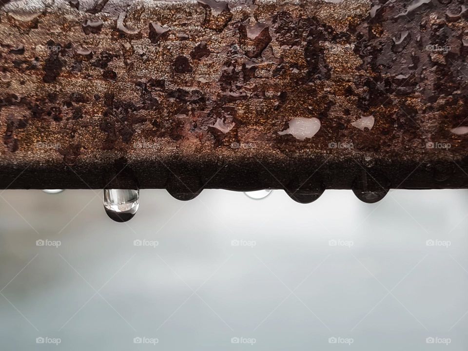 raindrops on the rusty railing