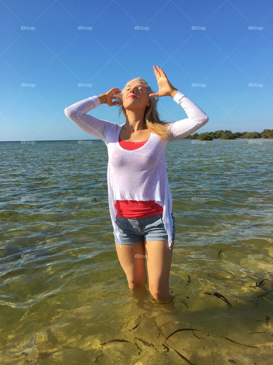 Young woman standing in sea