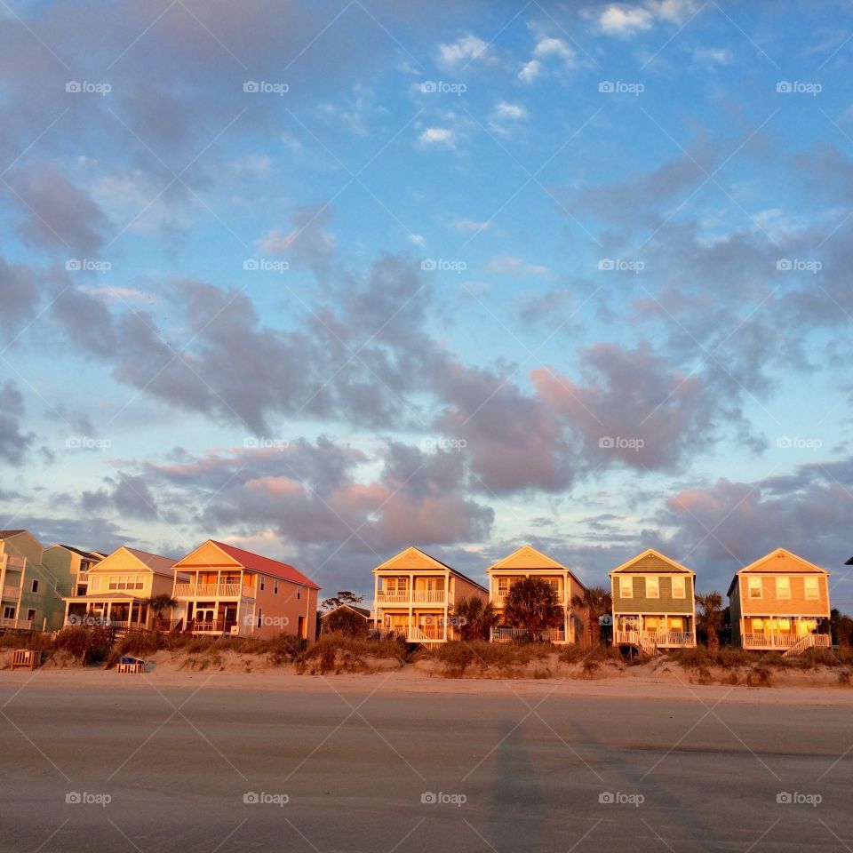 Beachhouses at sunrise. A row of colorful beach houses in golden morning light, Surfside Beach South Carolina