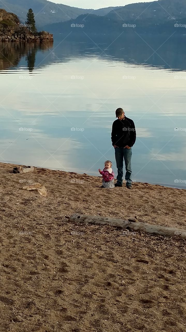Father and daughter near lake
