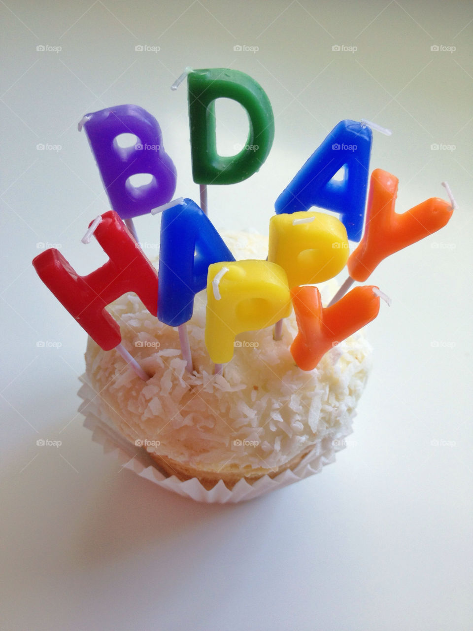 Happy birthday coconut cupcake with lettering candles