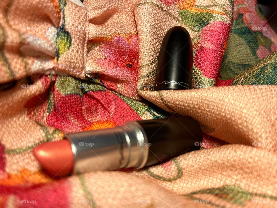 Coral lipstick on floral print