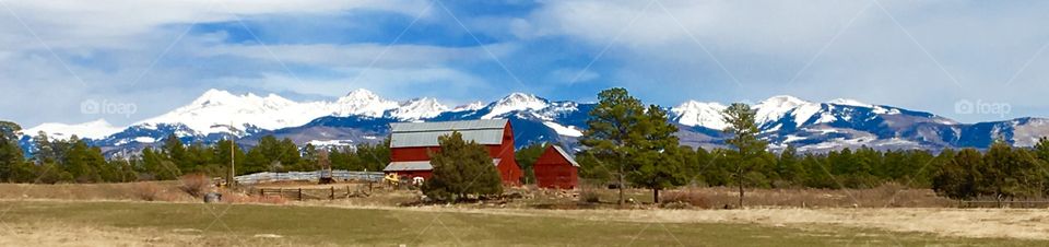 Red barn with snowy mountains 