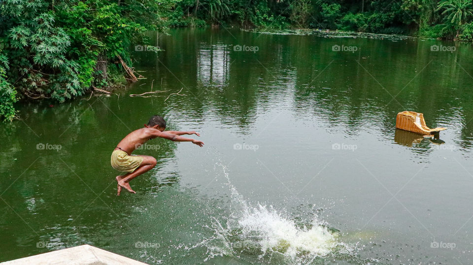 A splash story of a village boy who was jumping in to a pond for bathing...