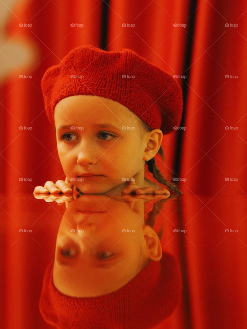 Portrait of cute little girl wearing red beret on red background, portrait of child 