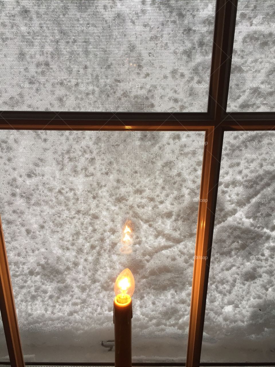 Snow window. Snow storm winter blizzard window candle 