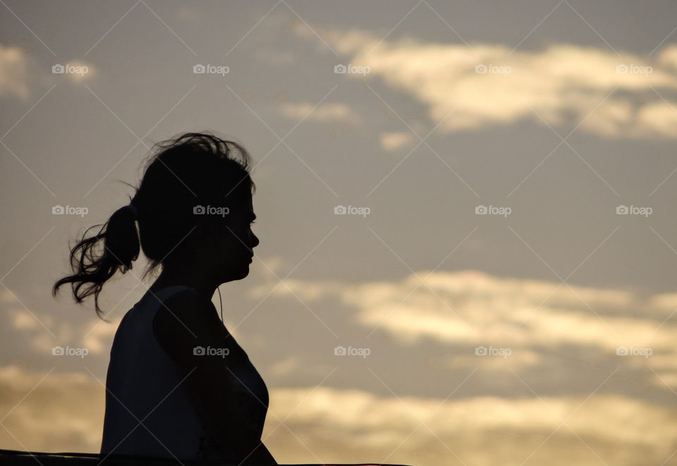 Girl walking past the sunset