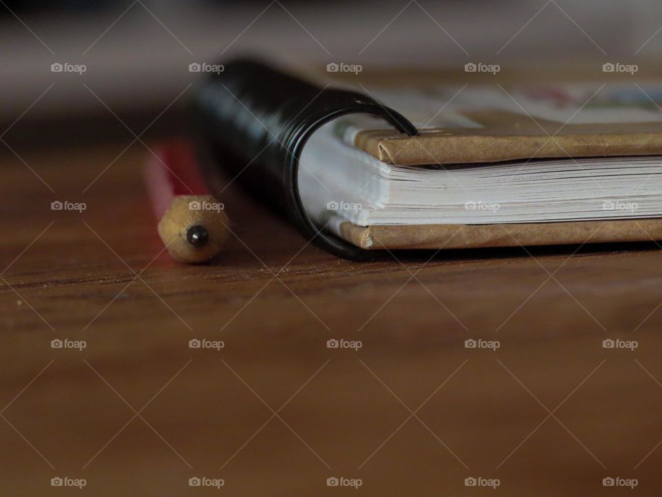 Pencil and notebook laying on a desk