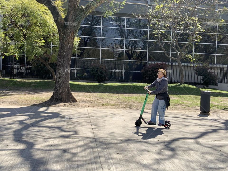 Woman on mono scooter in the city 