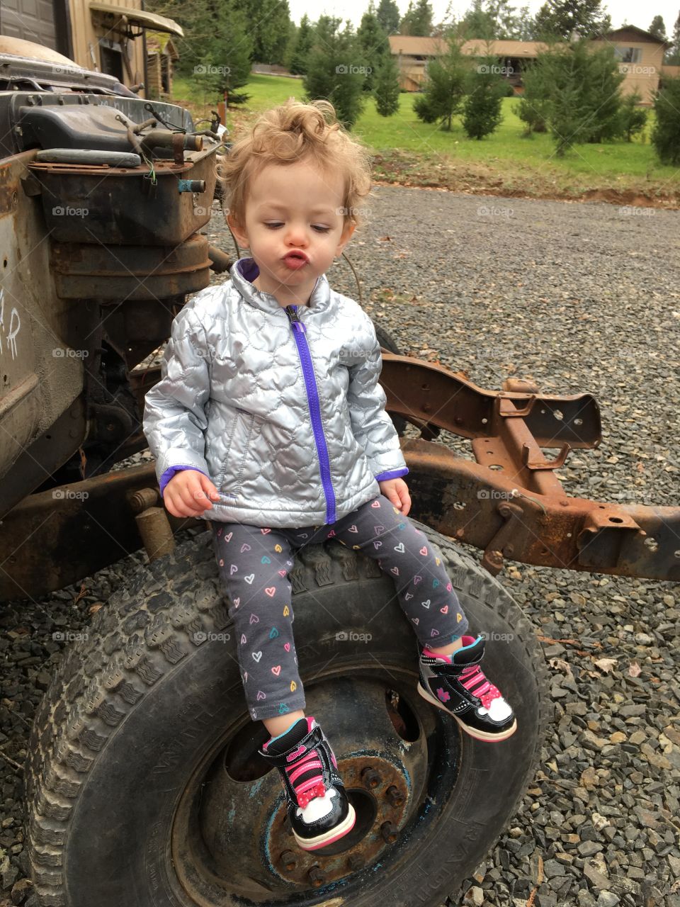Sitting on the tire of grandpa’s project truck