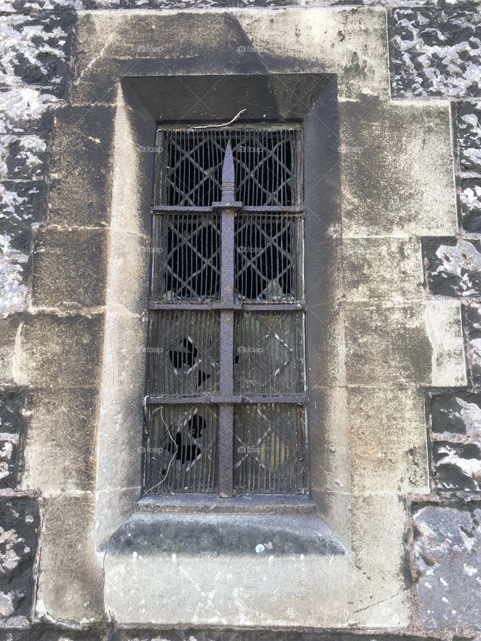Dilapidated and unloved and part of a structure of a house of god, surely this window deserves some loving attention urgently.