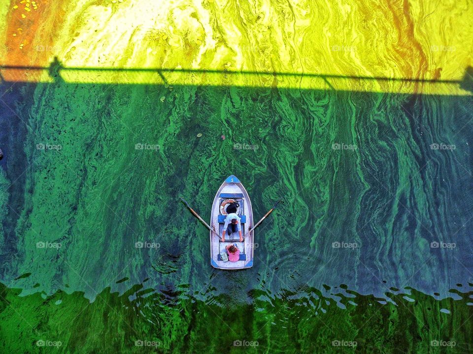 the boat floats on the green water of the Dnieper River