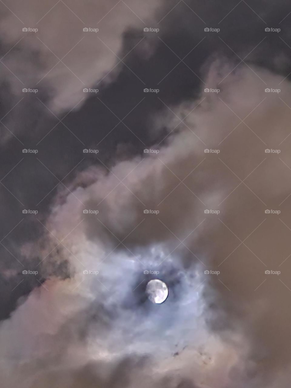 Clouds passing by the moon