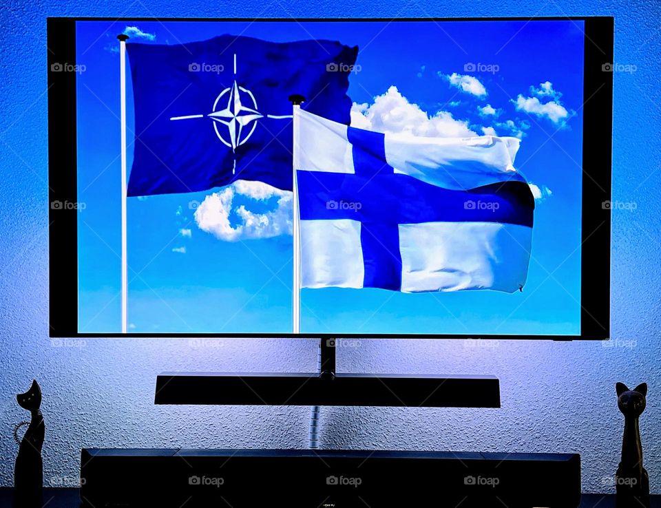 Finland joined NATO, both flags close on TV agains the bright blue sky with white clouds 🤍💙