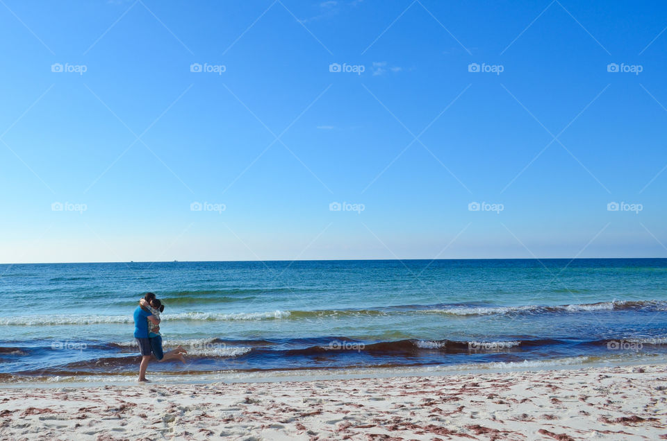 Couple embracing on a beach in the Gulf of Mexico