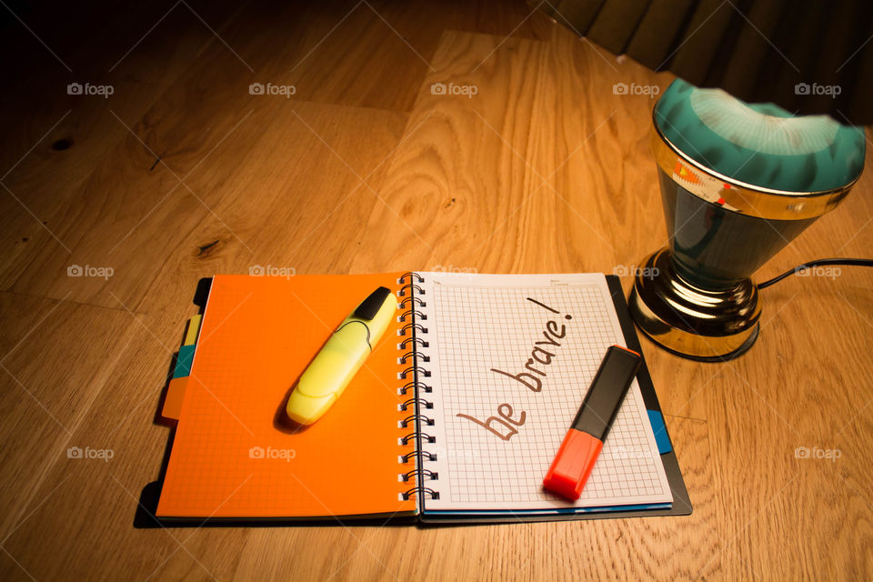 Motivational letter in a notebook on the desktop under the light of a lamp