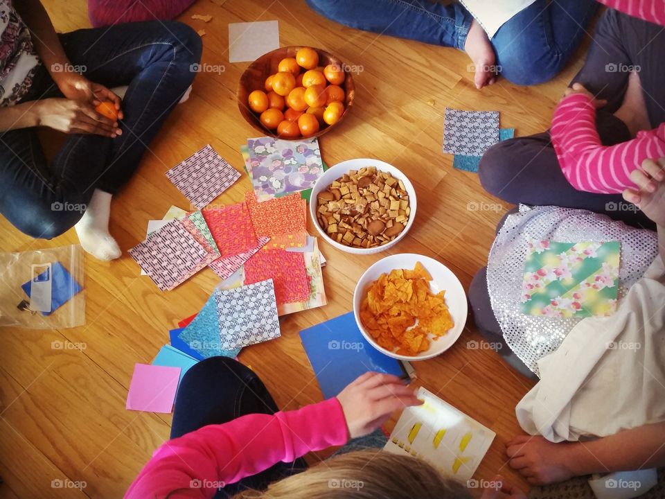 circle gathering of friends with snacks and crafts