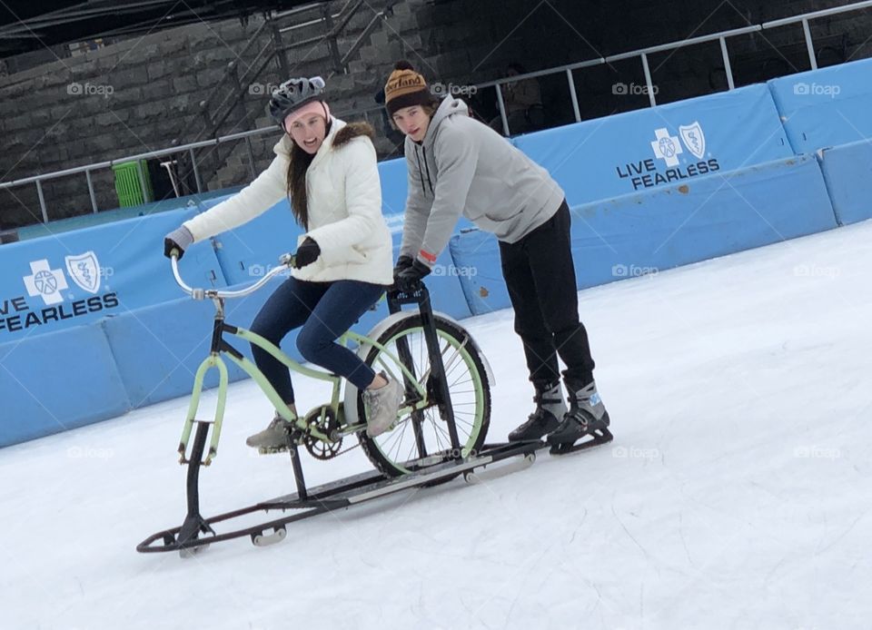 Winter fun with friends at the ice rink, are used bikes, are used gates, young people having fun