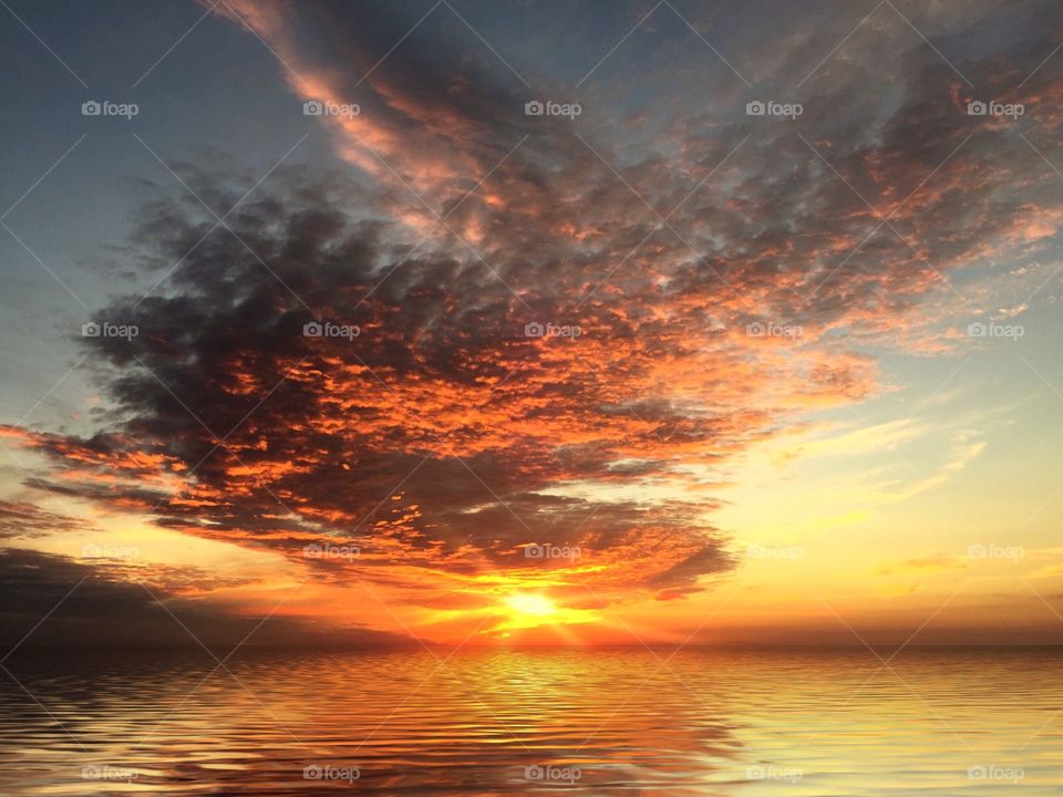 View of dramatic sky reflected on lake