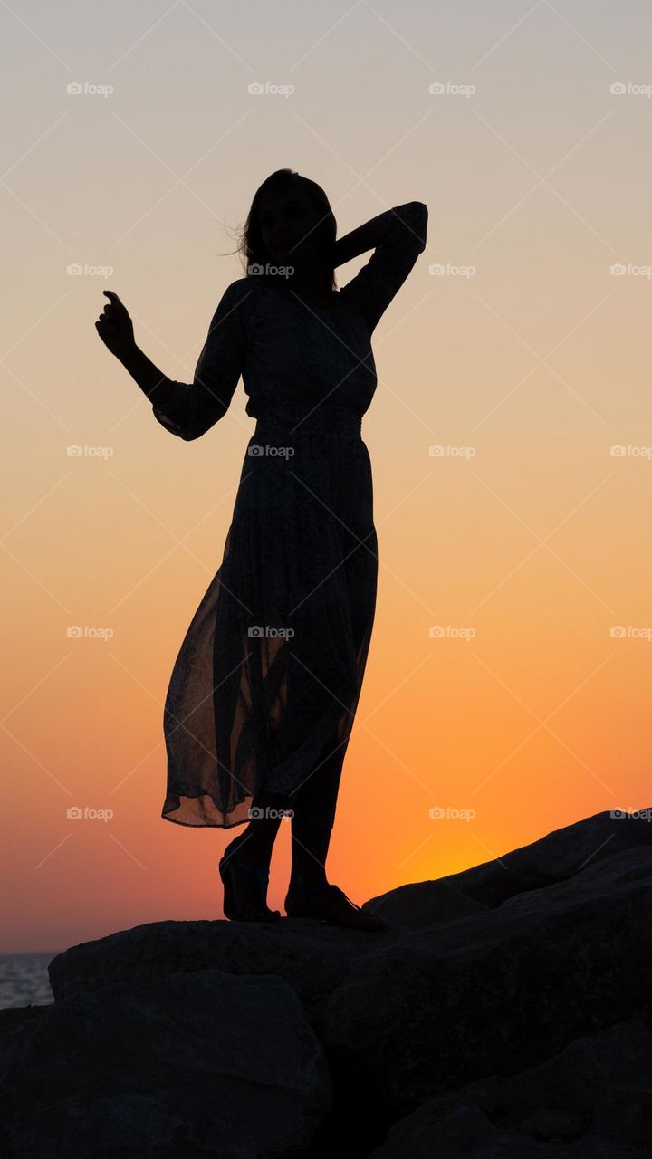 Woman’s silhouette against sunset 