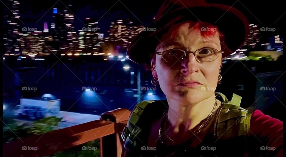 Standing on the staircase of the “Pulaski Bridge” at “Newtown Creek” I snapped a lovely selfie. I like the way the nighttime illumination brings out my face and how the sparkly electro lights of the city compliment it. 2022. Hypnotic Productions