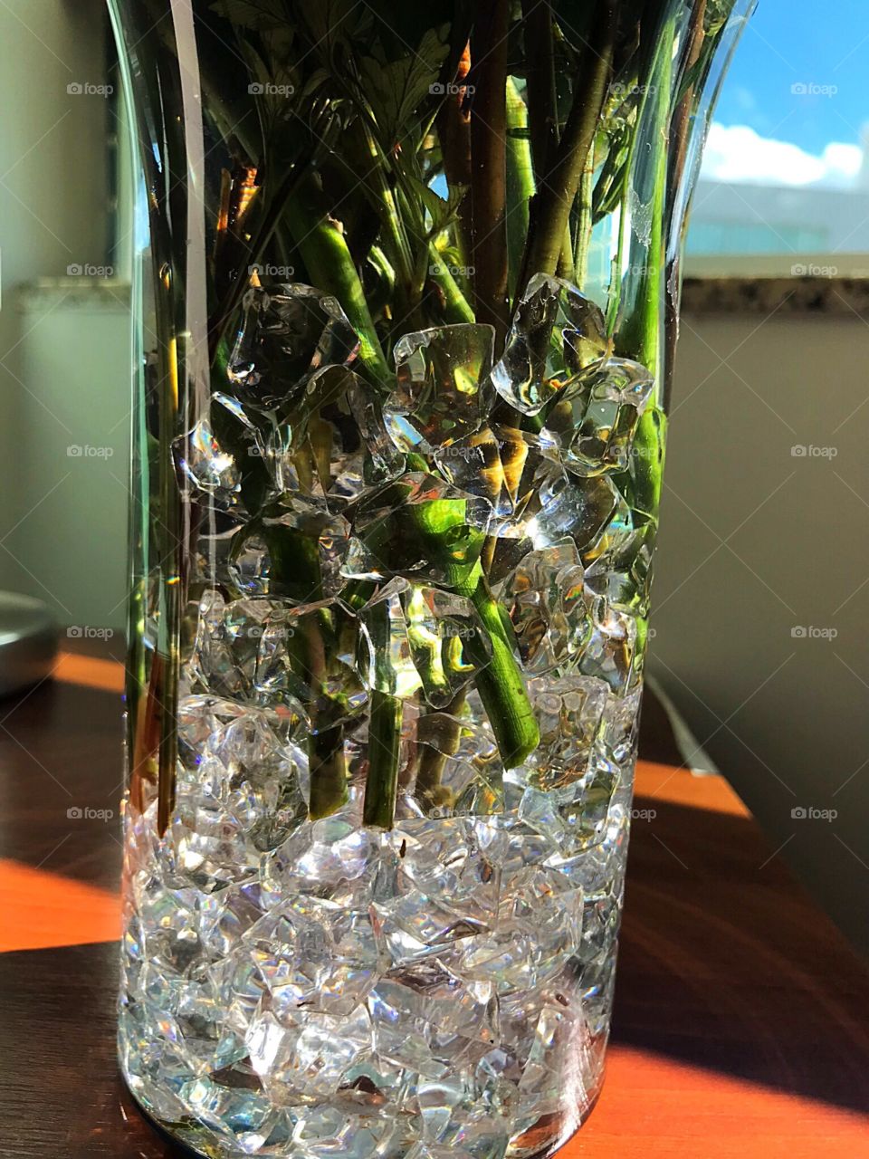 Vase with crystal stones and branches of roses