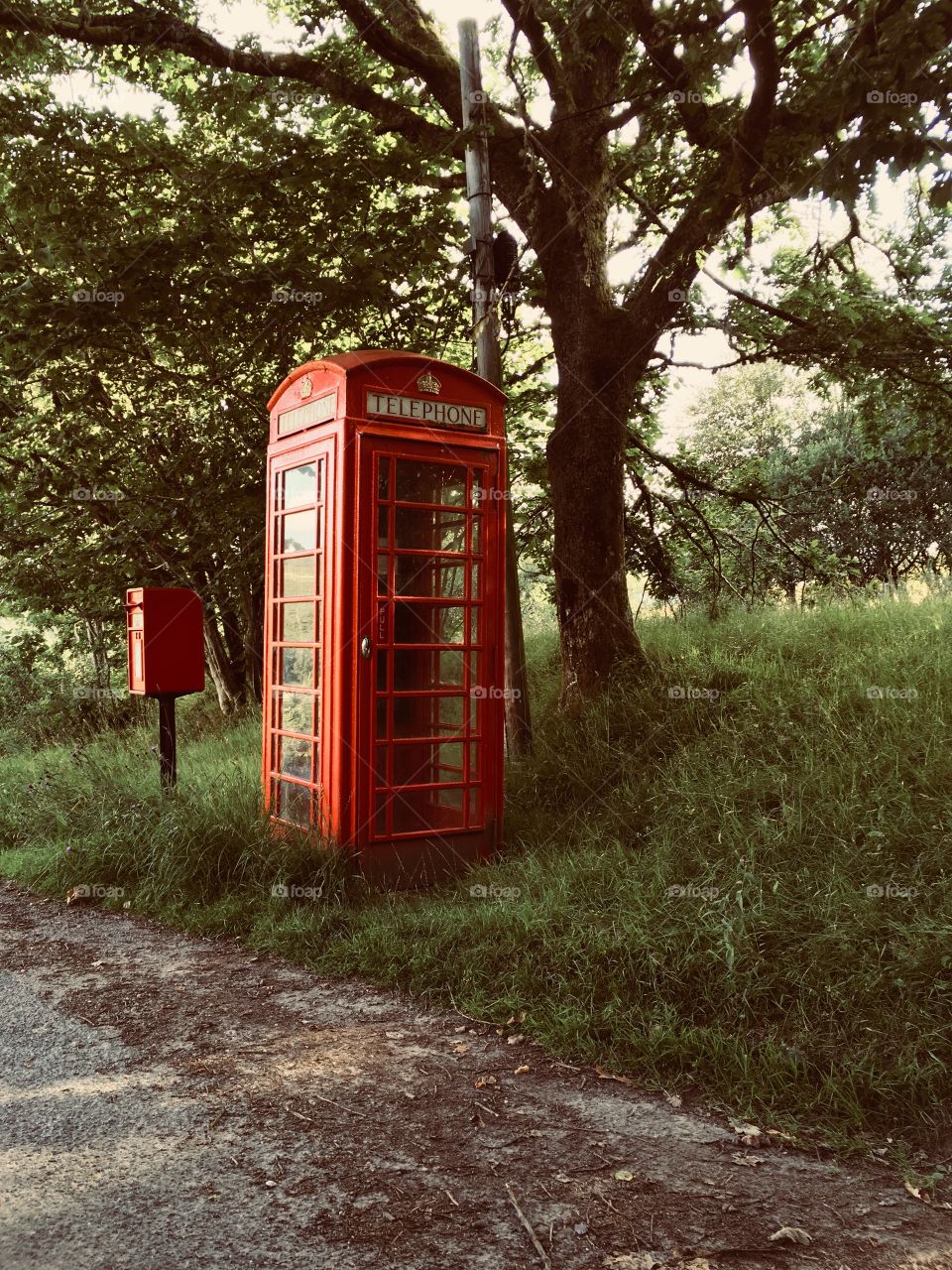 Old fashioned red phone box in the beautiful countryside