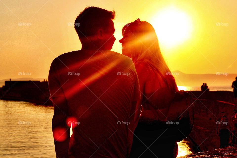 Young love at the sunset. Chania old port, Crete