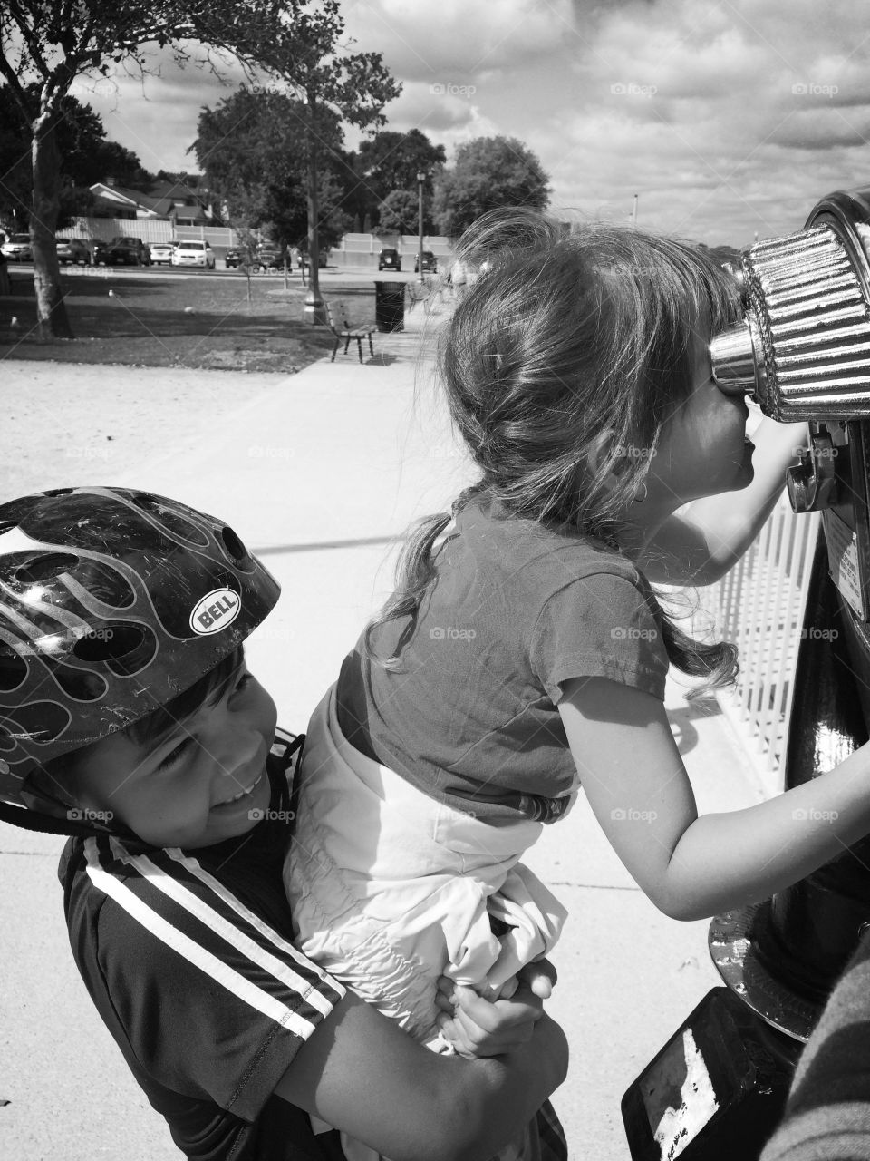 Boy carrying her sister
