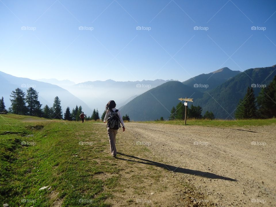 Walking in high mountain. Woman is walking in high mountain at summer