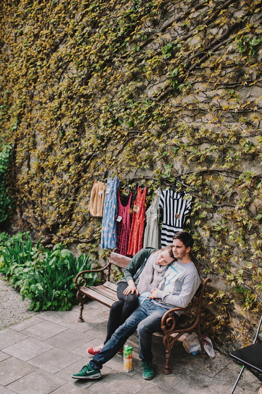 couple in front of green wall