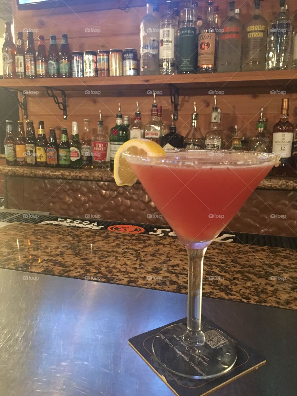 Fresh strawberry lemon drop martini served at an esthetically pleasing bar. 