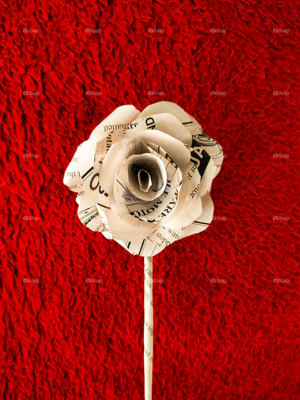 Paper rose on a red background.