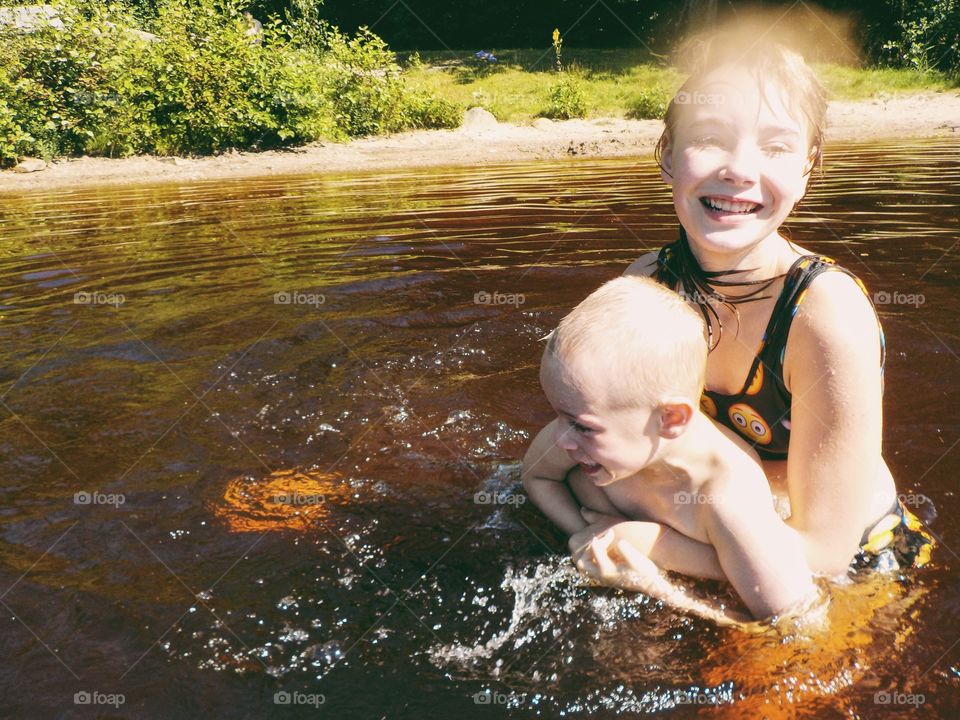 Two children having fun in the lake